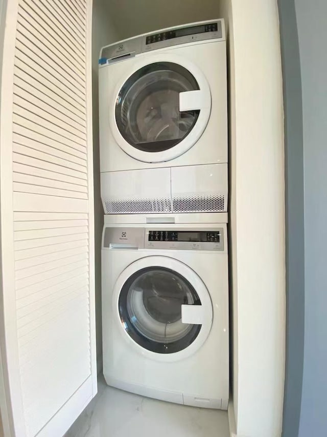 laundry room featuring stacked washer and dryer and laundry area