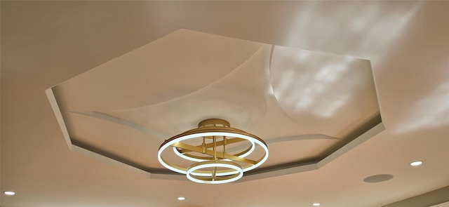 interior details featuring recessed lighting and a tray ceiling