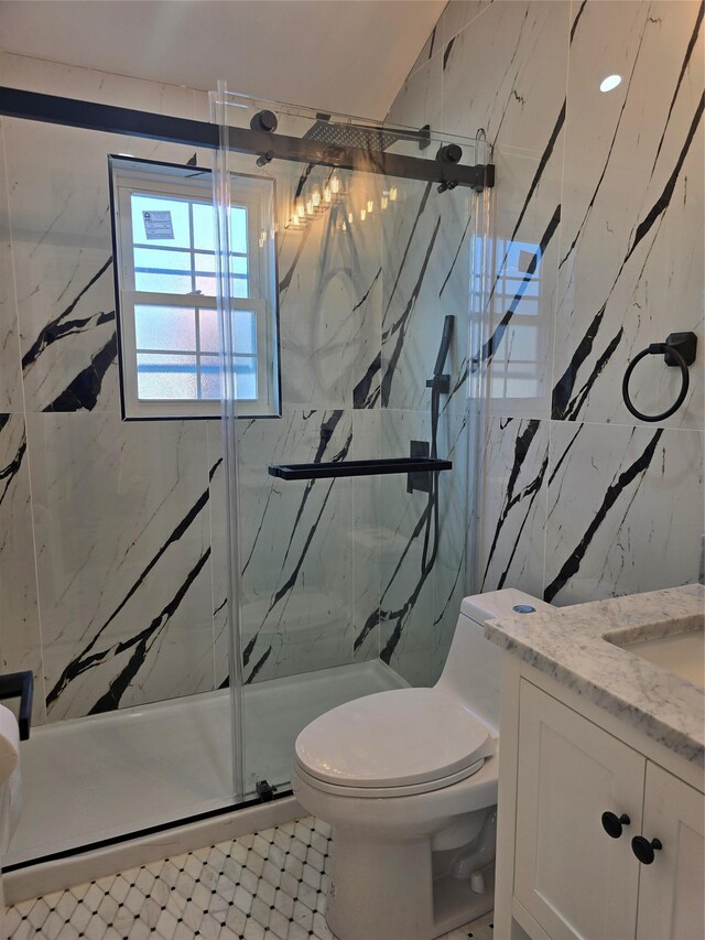 full bath with vanity, tile walls, toilet, and a marble finish shower