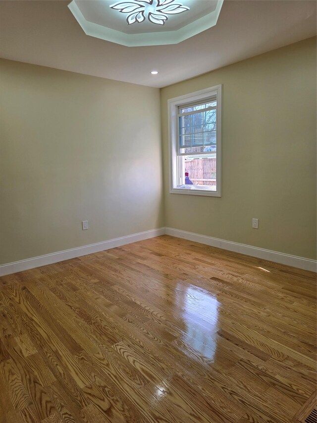 empty room featuring wood finished floors and baseboards