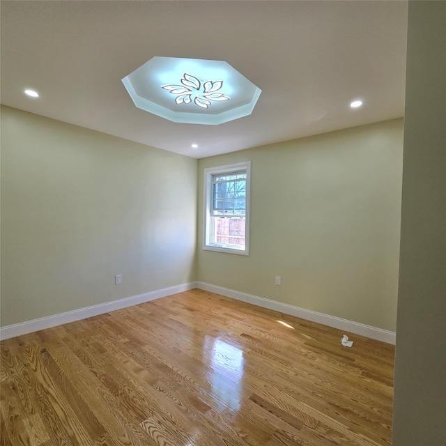 unfurnished room featuring recessed lighting, light wood-style flooring, and baseboards