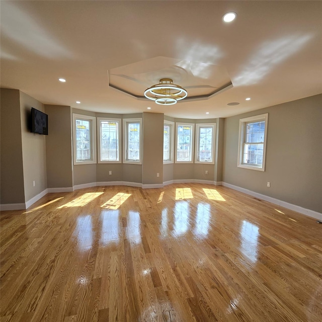 empty room with recessed lighting, baseboards, and wood finished floors