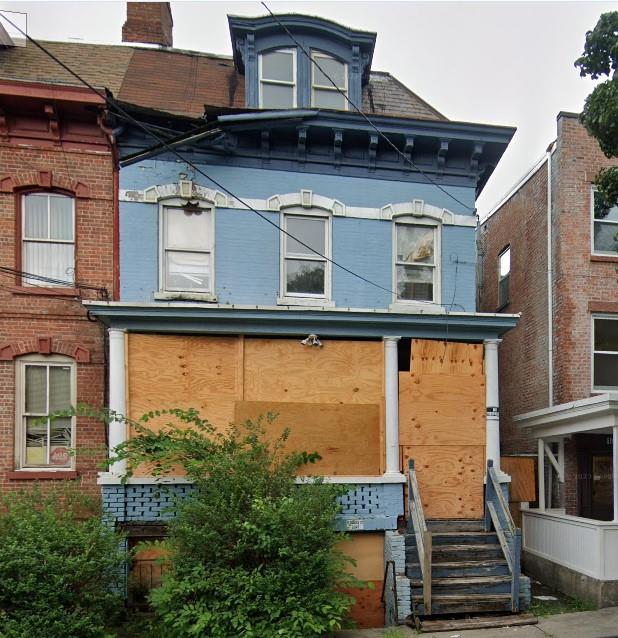 rear view of property featuring a chimney