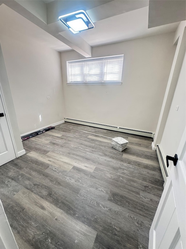 interior space featuring wood finished floors, baseboards, and baseboard heating