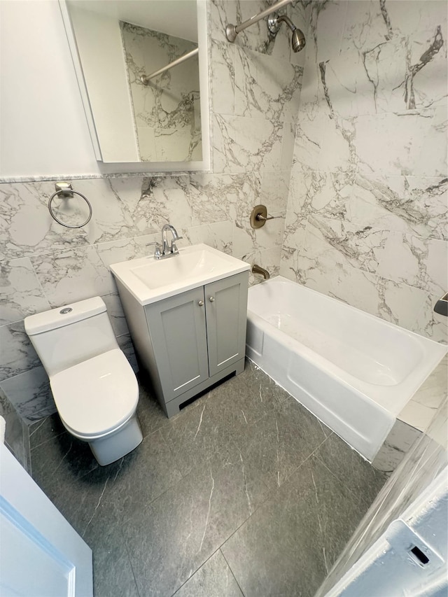 bathroom with vanity, toilet, marble finish floor, and bathing tub / shower combination