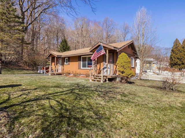 view of front of property with a front lawn and fence