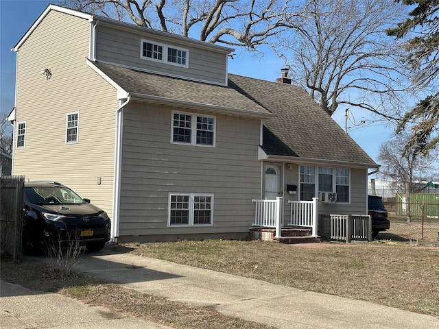 view of front of home featuring driveway, fence, a chimney, and a shingled roof