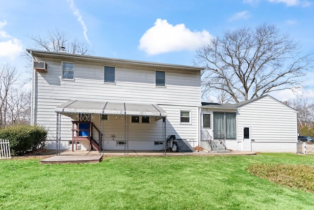 rear view of property with a lawn, fence, and a wall mounted air conditioner