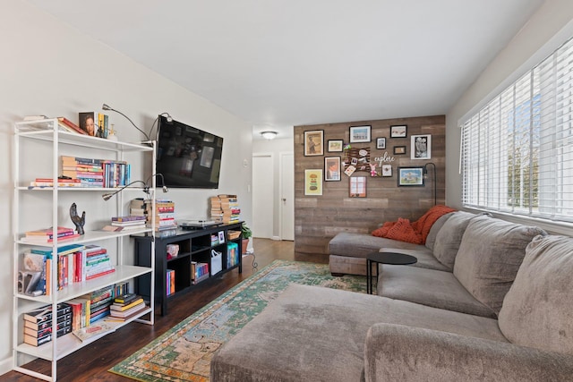 living room with wood finished floors and wood walls