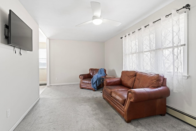 sitting room featuring carpet flooring, baseboards, ceiling fan, and a baseboard radiator