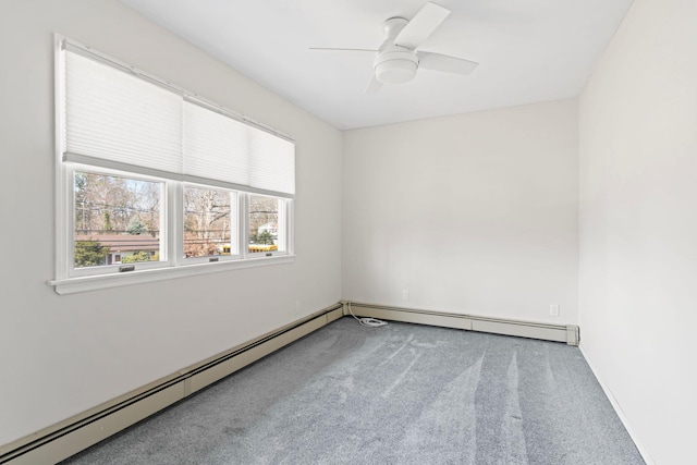 spare room featuring carpet flooring, a ceiling fan, and a baseboard radiator