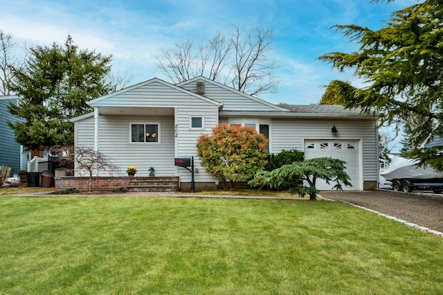 view of front of house featuring an attached garage, driveway, and a front lawn