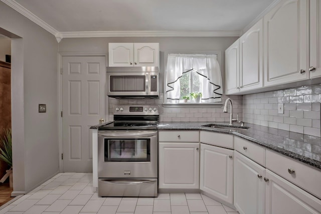 kitchen featuring tasteful backsplash, white cabinetry, stainless steel appliances, and a sink