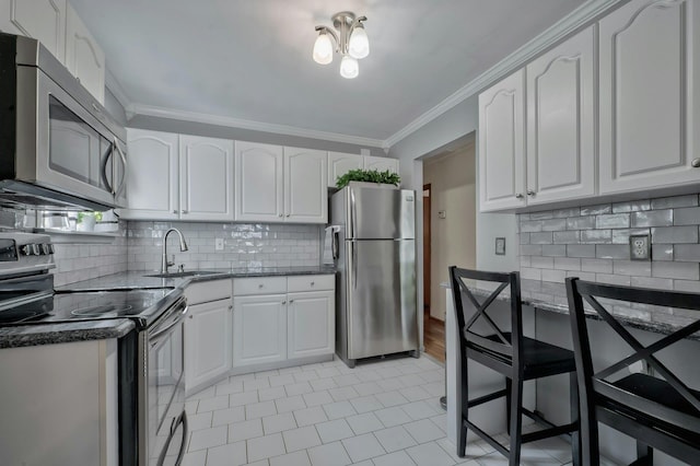 kitchen featuring a sink, crown molding, tasteful backsplash, and stainless steel appliances