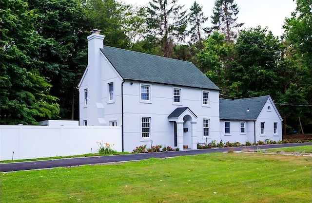 38 Highfield Rd, Glen Cove, NY 11542 - view of front of house with a chimney, a shingled roof, and stucco siding
