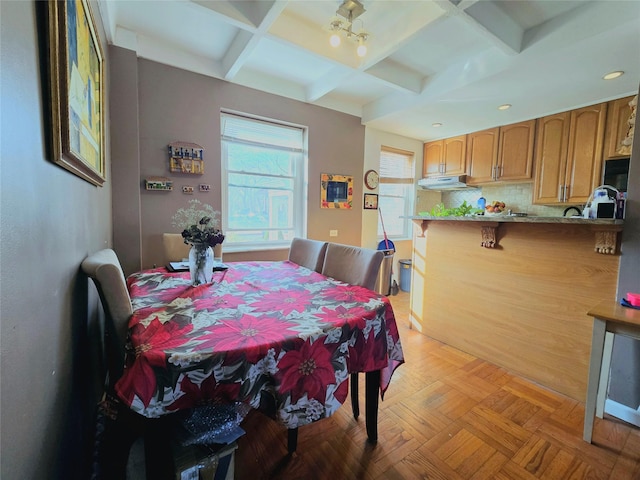 dining area featuring beam ceiling and coffered ceiling