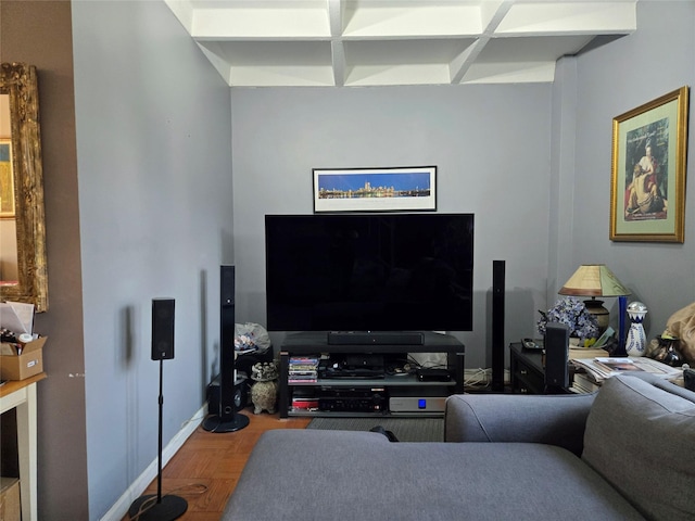 living room with coffered ceiling and baseboards