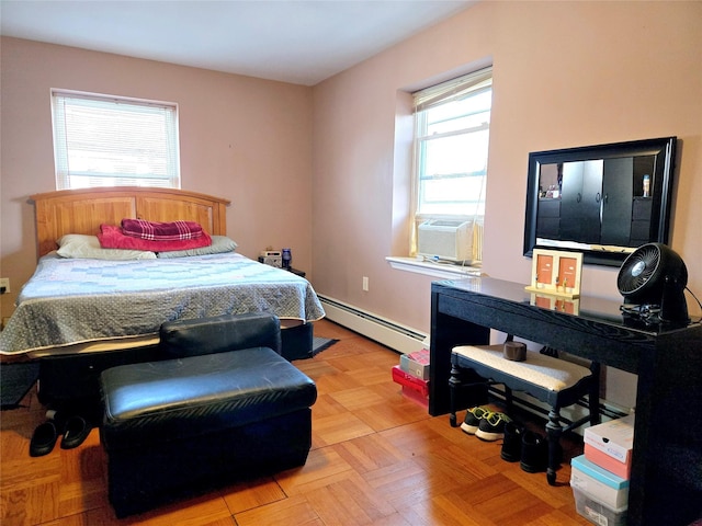 bedroom with cooling unit and a baseboard radiator