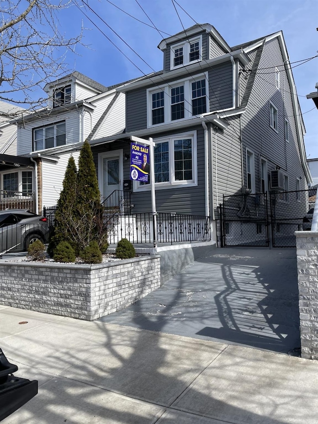 traditional style home with a gate and a fenced front yard