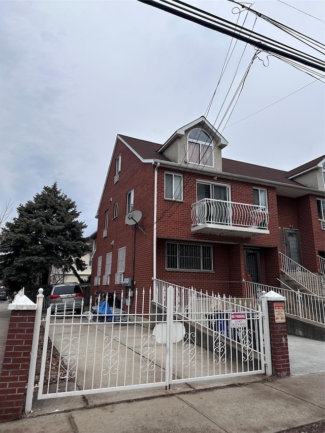 view of property featuring brick siding and a fenced front yard