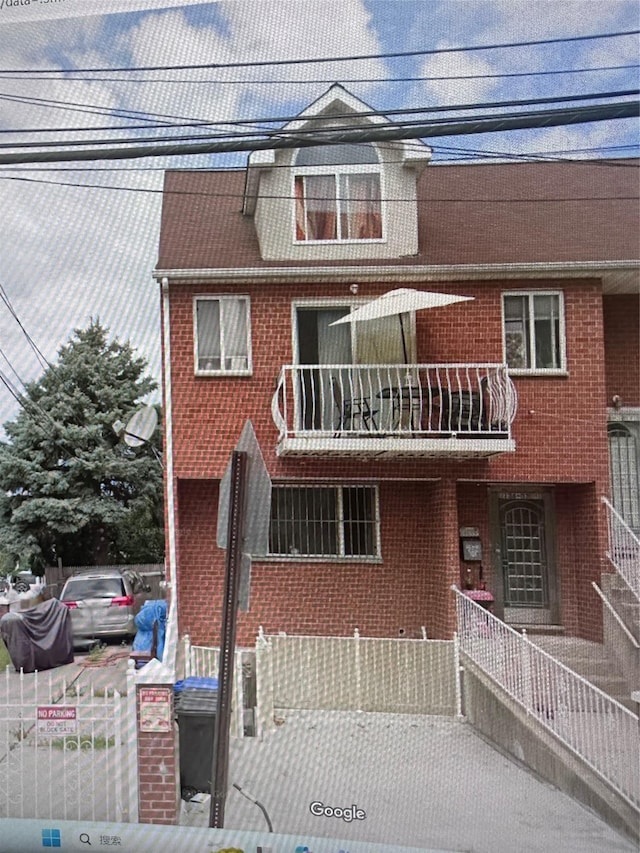 view of front of home with brick siding and fence