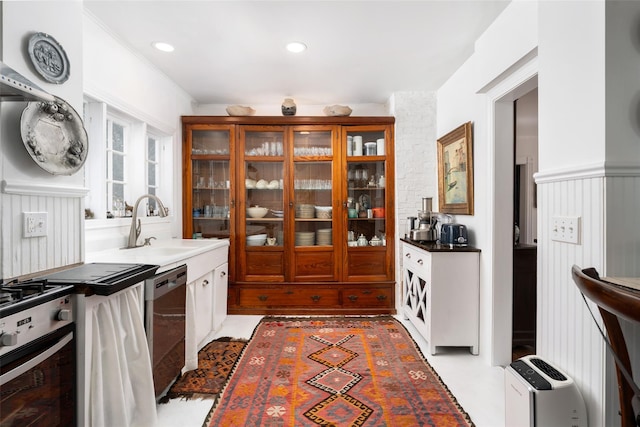 kitchen featuring recessed lighting, appliances with stainless steel finishes, ornamental molding, and a sink