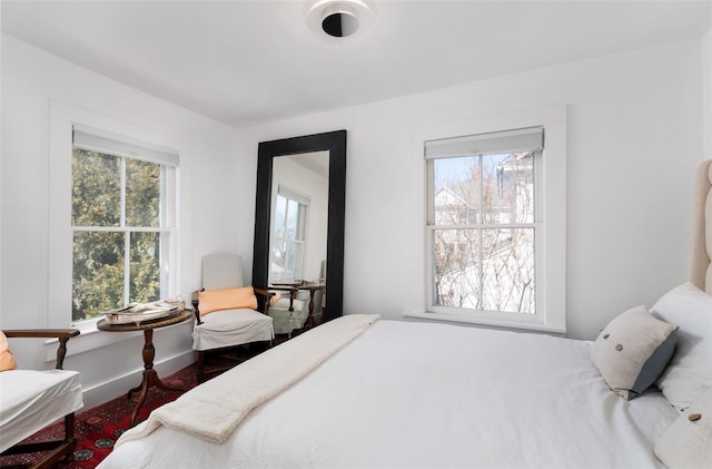 bedroom with baseboards and wood finished floors