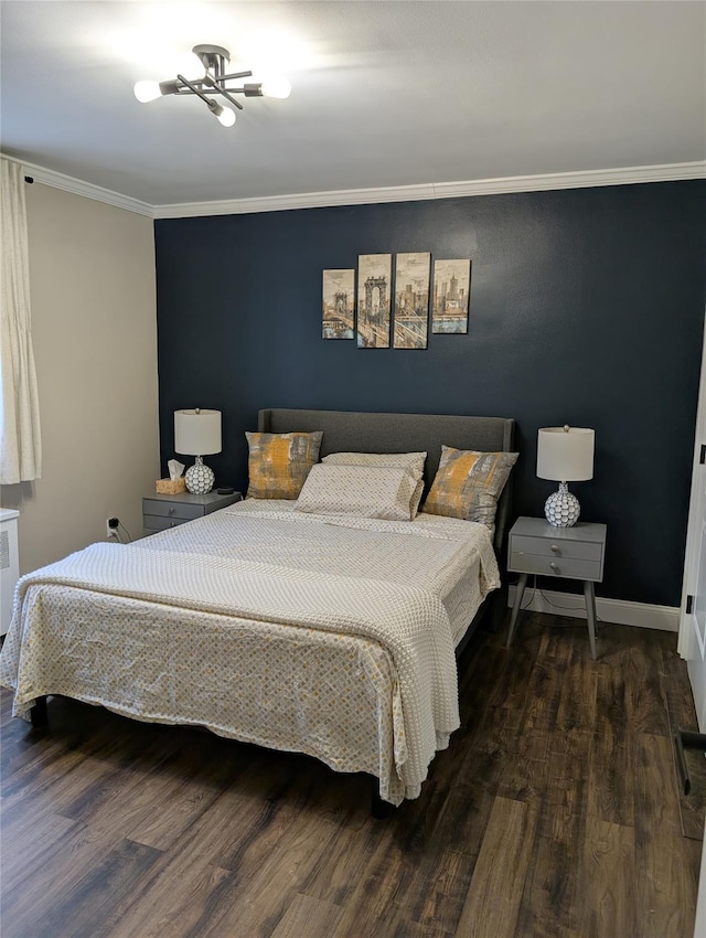 bedroom featuring baseboards, wood finished floors, crown molding, and radiator heating unit