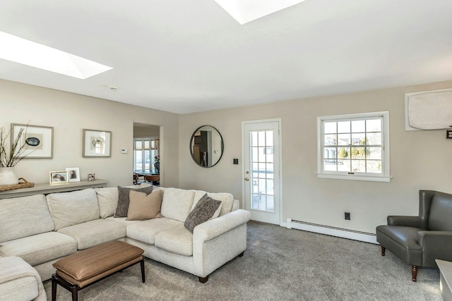 living room featuring a healthy amount of sunlight, a skylight, carpet, and a baseboard radiator