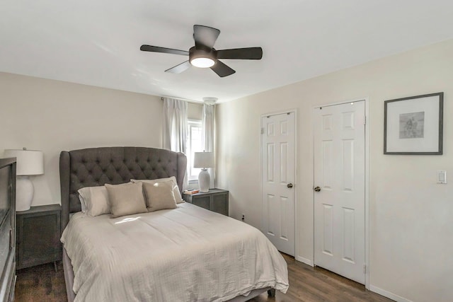 bedroom with baseboards, ceiling fan, and dark wood-style flooring