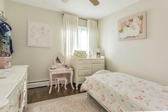 bedroom featuring a ceiling fan, dark wood-style flooring, and baseboard heating