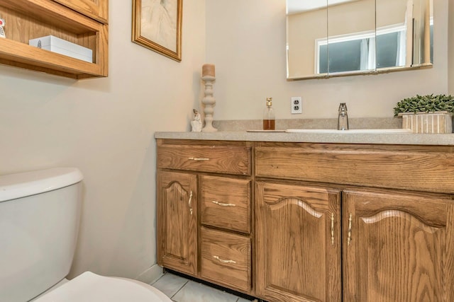 bathroom featuring toilet and vanity