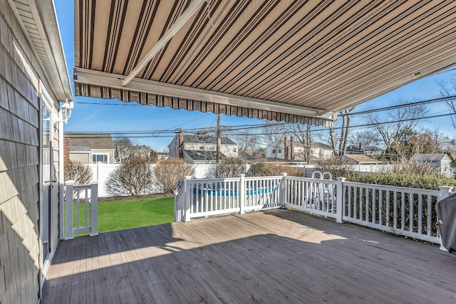 wooden terrace with a yard, a fenced in pool, and a fenced backyard