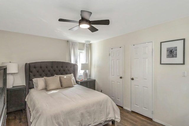 bedroom featuring ceiling fan, dark wood-type flooring, and baseboards