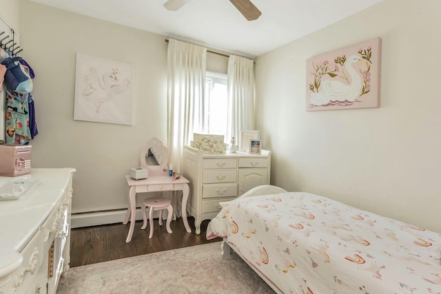 bedroom featuring dark wood-style floors, a ceiling fan, and a baseboard radiator