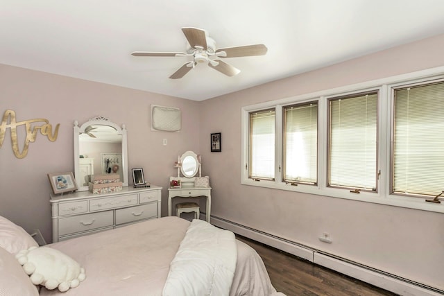 bedroom featuring wood finished floors, baseboard heating, and ceiling fan