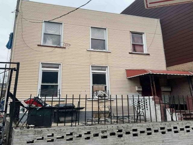 rear view of house with fence