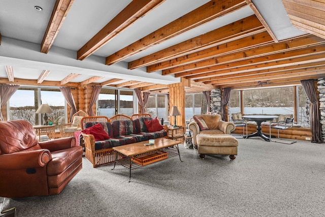 carpeted living room featuring beamed ceiling