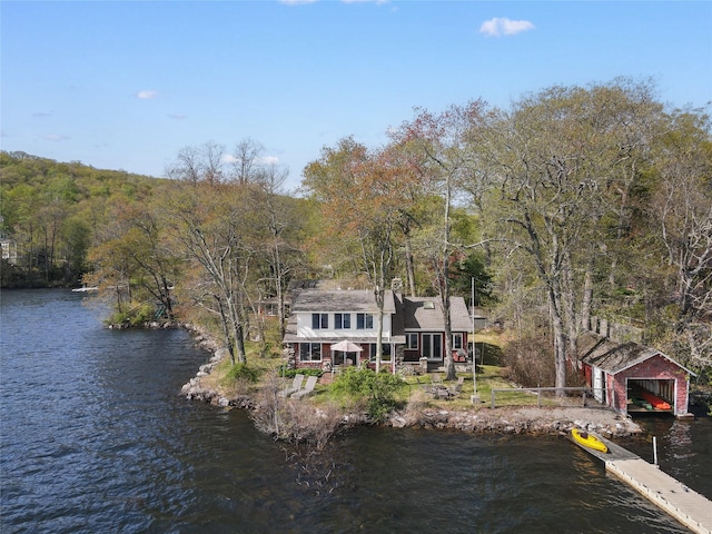 exterior space with a water view and a forest view