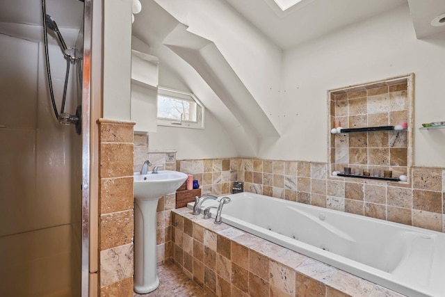 full bath with a whirlpool tub, a sink, and walk in shower
