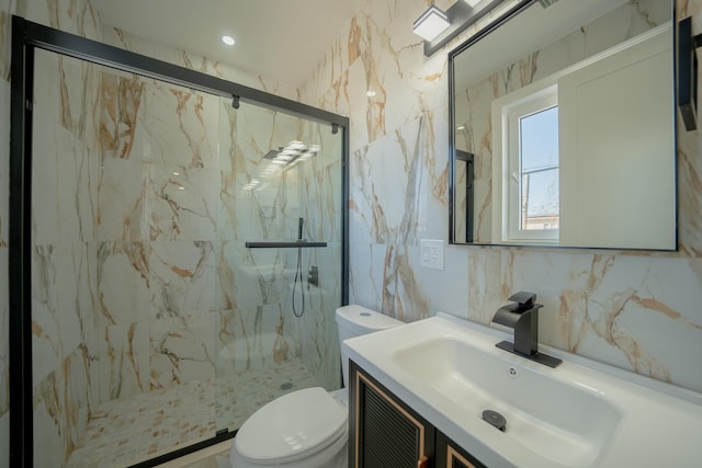 bathroom featuring toilet, backsplash, a marble finish shower, tile walls, and vanity