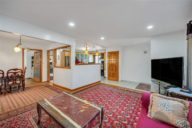 living area featuring recessed lighting and baseboards