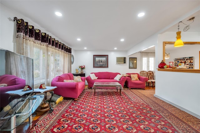 living room featuring recessed lighting and an AC wall unit