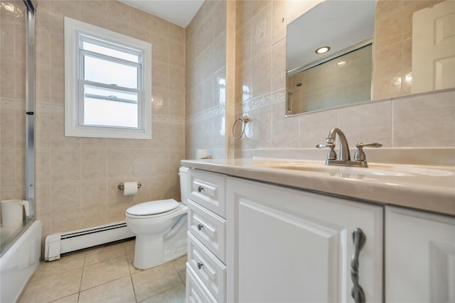 bathroom featuring tile walls, a baseboard heating unit, toilet, tile patterned floors, and vanity