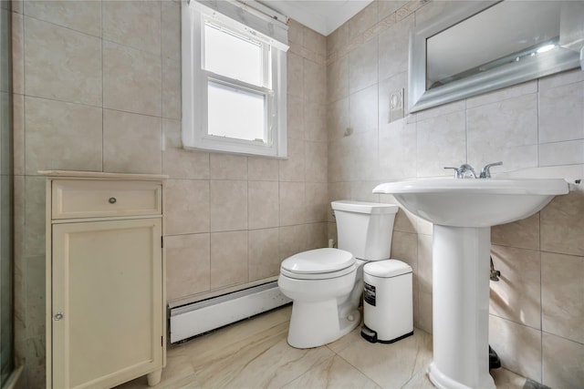 bathroom featuring a baseboard radiator, toilet, and tile walls