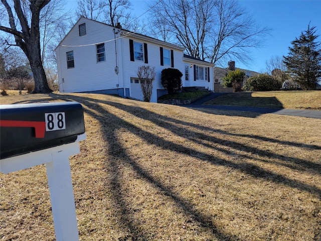 split foyer home with a front lawn