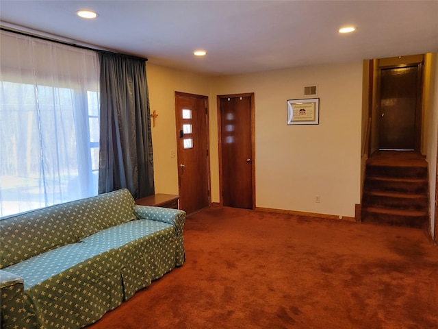 living room with visible vents, carpet floors, baseboards, recessed lighting, and stairs