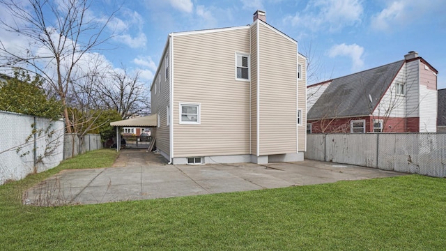 back of house with a lawn and fence