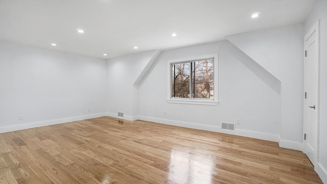 bonus room featuring light wood-style flooring, recessed lighting, visible vents, and baseboards