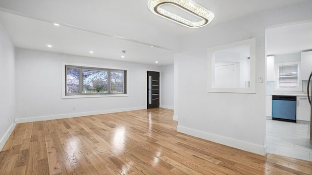 empty room with recessed lighting, baseboards, and light wood finished floors